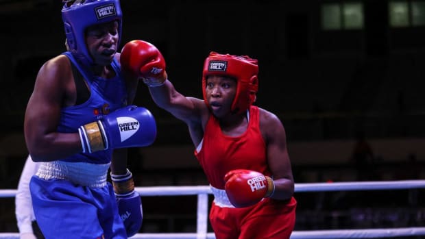 Nigeria's Patricia Mbata (R) attacks South Africa's Mkateko (L), during their elite women's 70-75kg middle bout, at the African Boxing Championships in Yaounde in August 2023. Mbata, a British born boxer of Nigerian descent was invited by the Nigerian Boxing Federation to fight for the national team. DANIEL BELOUMOU OLOMO/AFP VIA GETTY IMAGES.